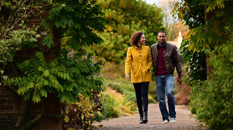 A couple walking in Rowallane Garden, County Down